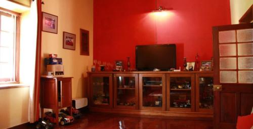 Recreational room having TV and children's toys and natural light coming in through a window