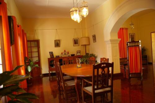 Indoor dining table and chairs with orange themed curtains