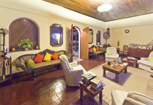 View of the lounge area having white sofas, coffee tables and other furniture