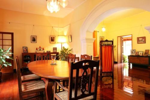 A daytime view of the dining room with table and chairs among other furniture