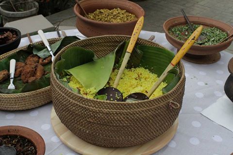 Yellow rice in a wicker basket lined with banana leaf